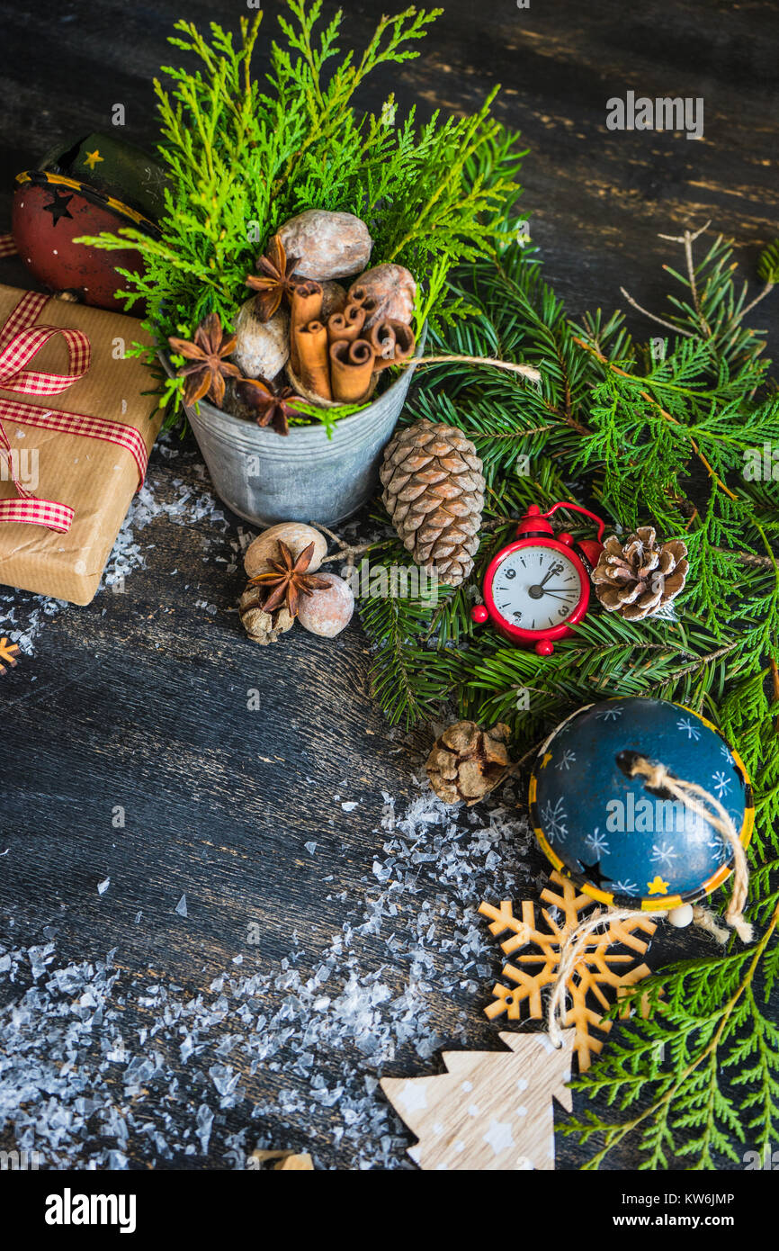 Christmas frame with fir tree branch, red berries and decorations on ...