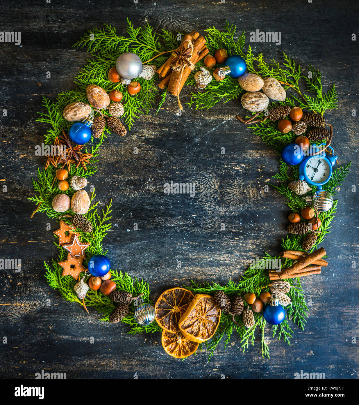 Christmas frame with fir tree branch, red berries and decorations on ...