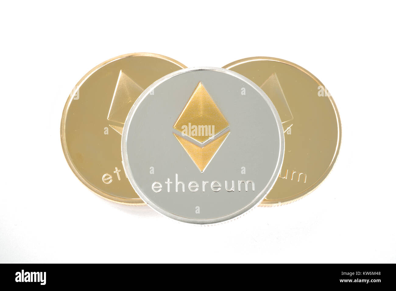 Three real coins of cryptocurrency Silver and golden Ethereum isolated on white background Stock Photo