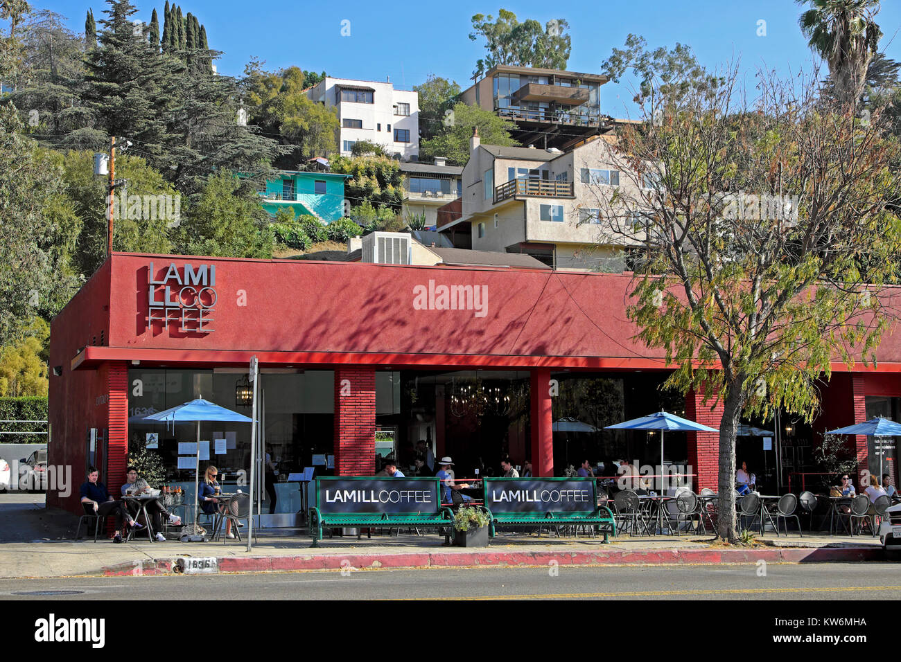 People sitting at outside tables drinking beverages at LAMILL COFFEE