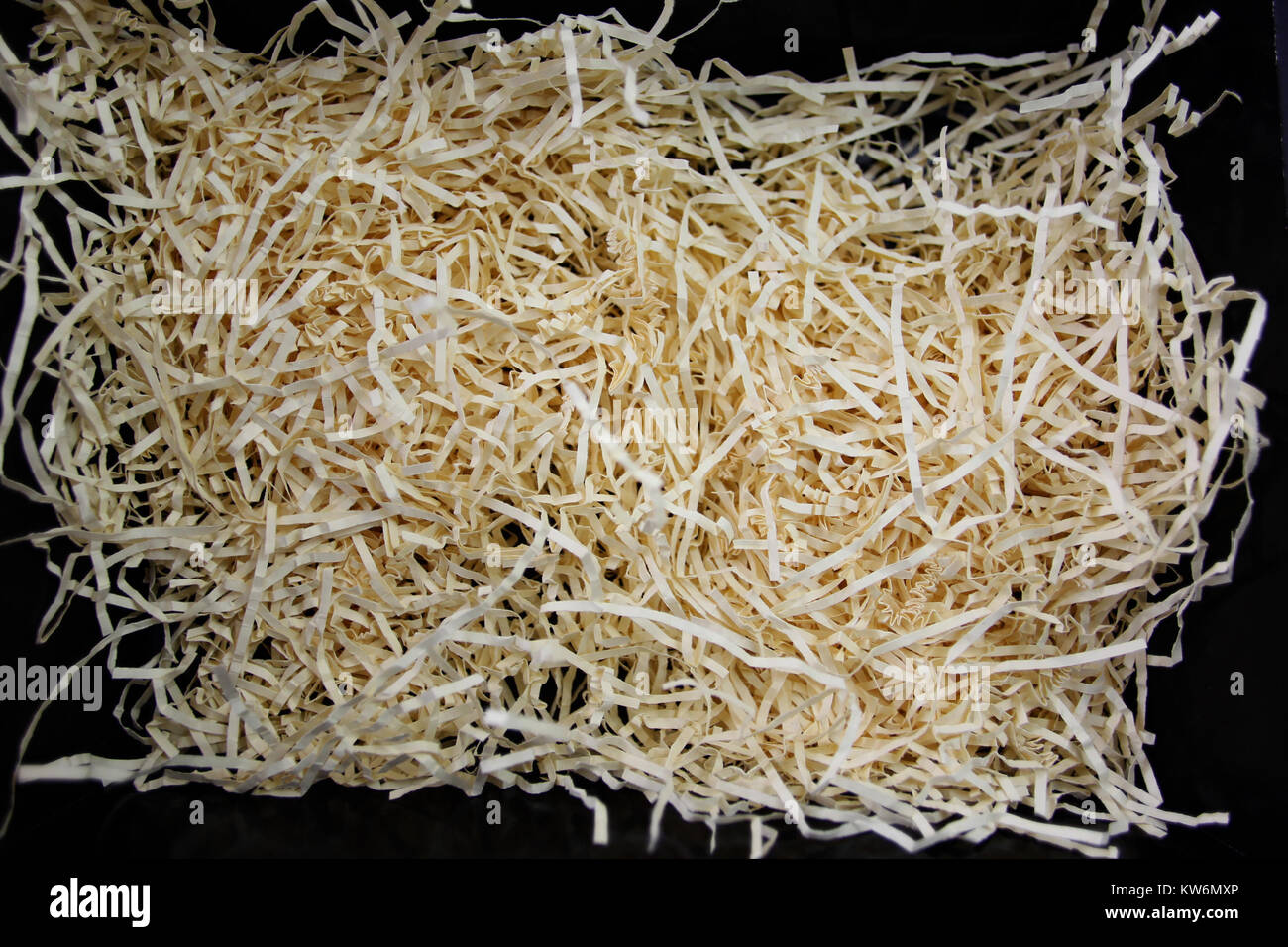 Shredded paper packaging on a black background Stock Photo Alamy