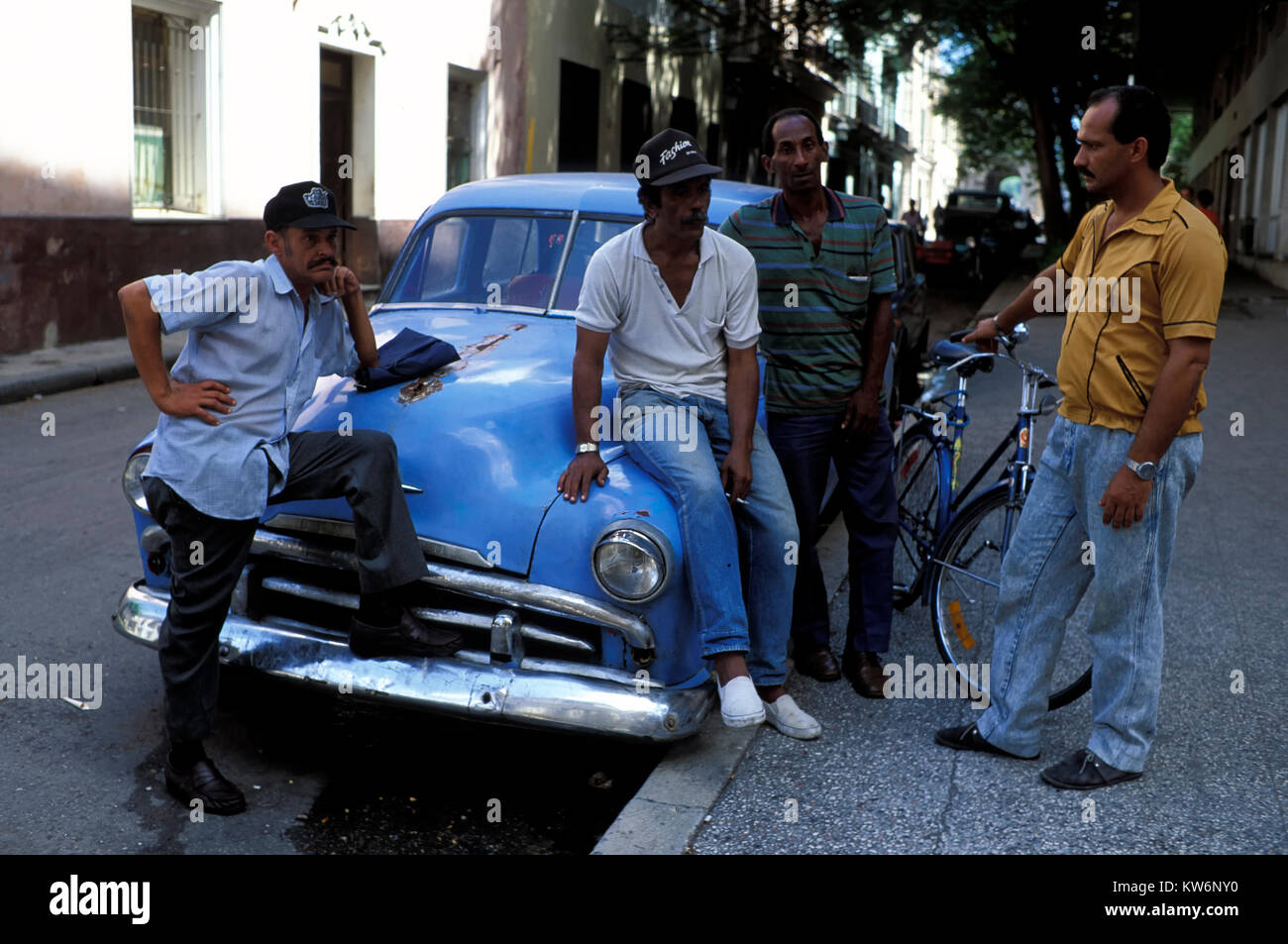 Men and  Oldtimer, Trinidad, Cuba Stock Photo