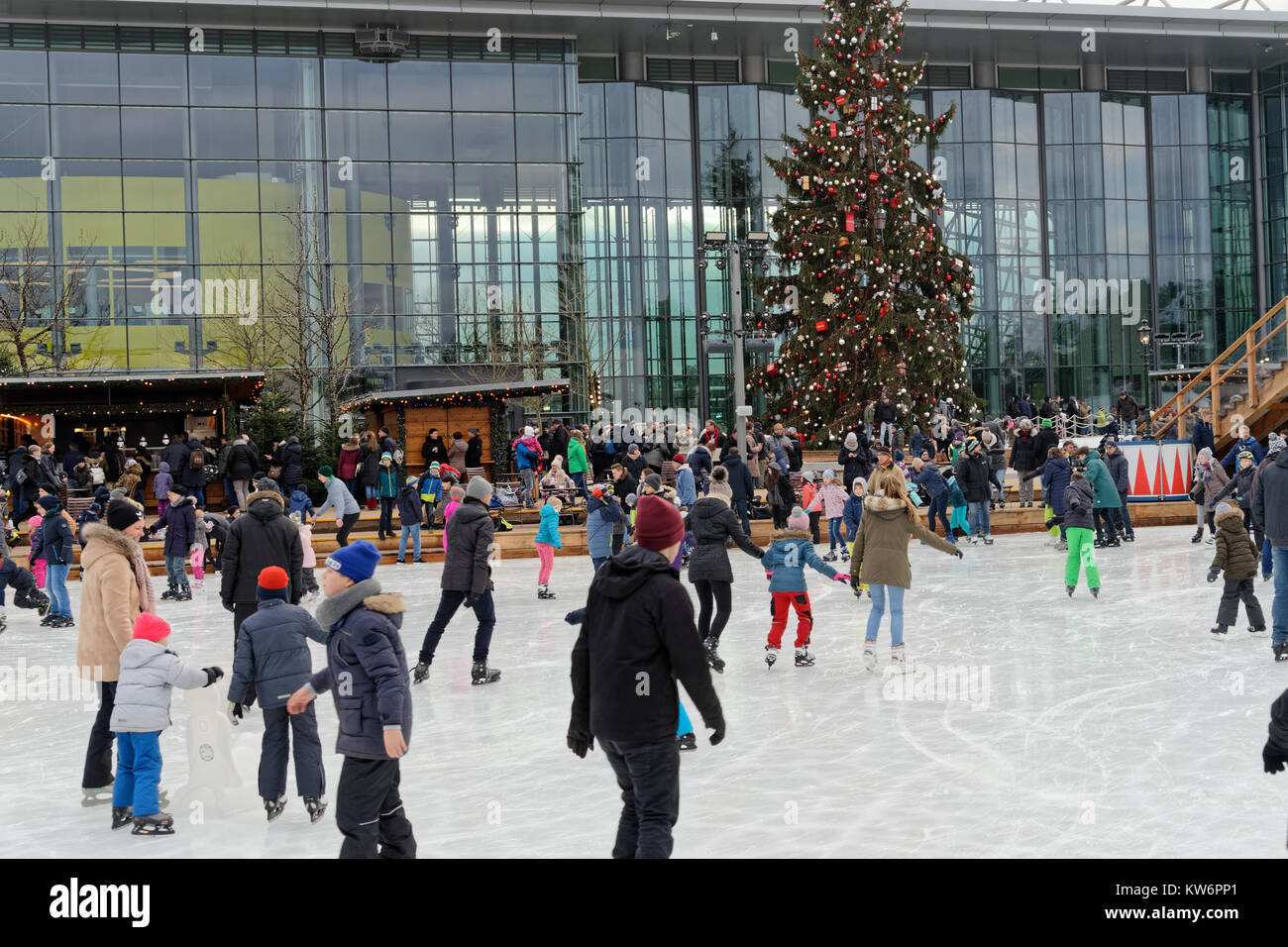 Wolfsburg, Lower Saxony, December 17 2017: Artificially icy lagoon in the Autostadt with many people skating. Stock Photo