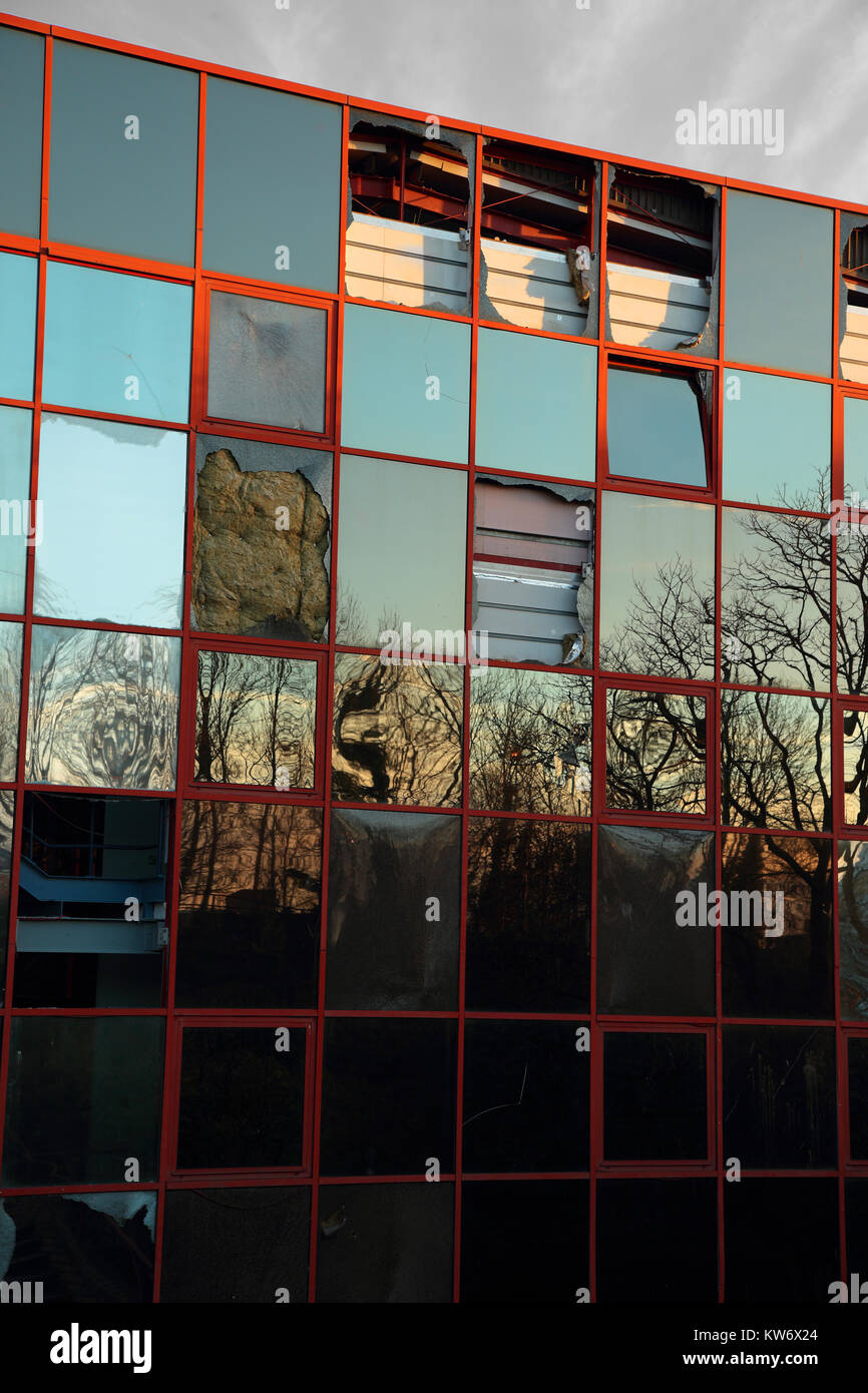 Abandoned vandalised glass fronted office building Stock Photo - Alamy