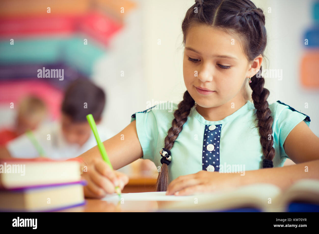 Cute smiling schoolgirl at school during lesson Stock Photo - Alamy