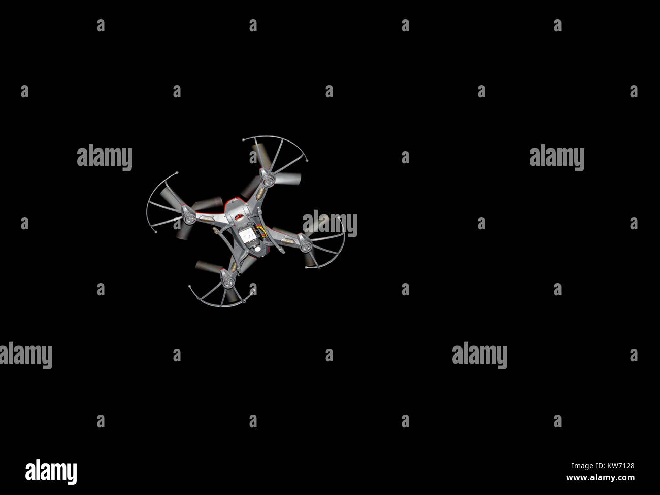 Small drone hovering flying at night Stock Photo - Alamy