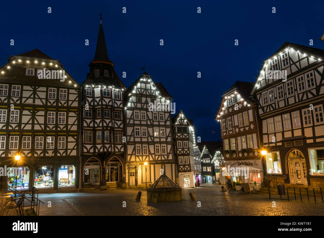 FRITZLAR, GERMANY: 25th December 2017: The marketplace of Fritzlar with fountain and fairy lights during blue hour Stock Photo