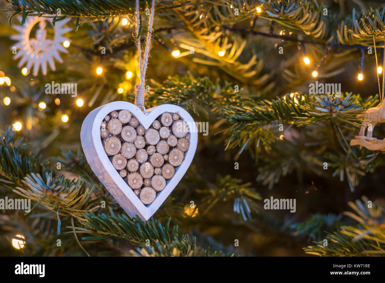 Wooden Heart Ornament Hanging On A Christmas Tree With Fairy
