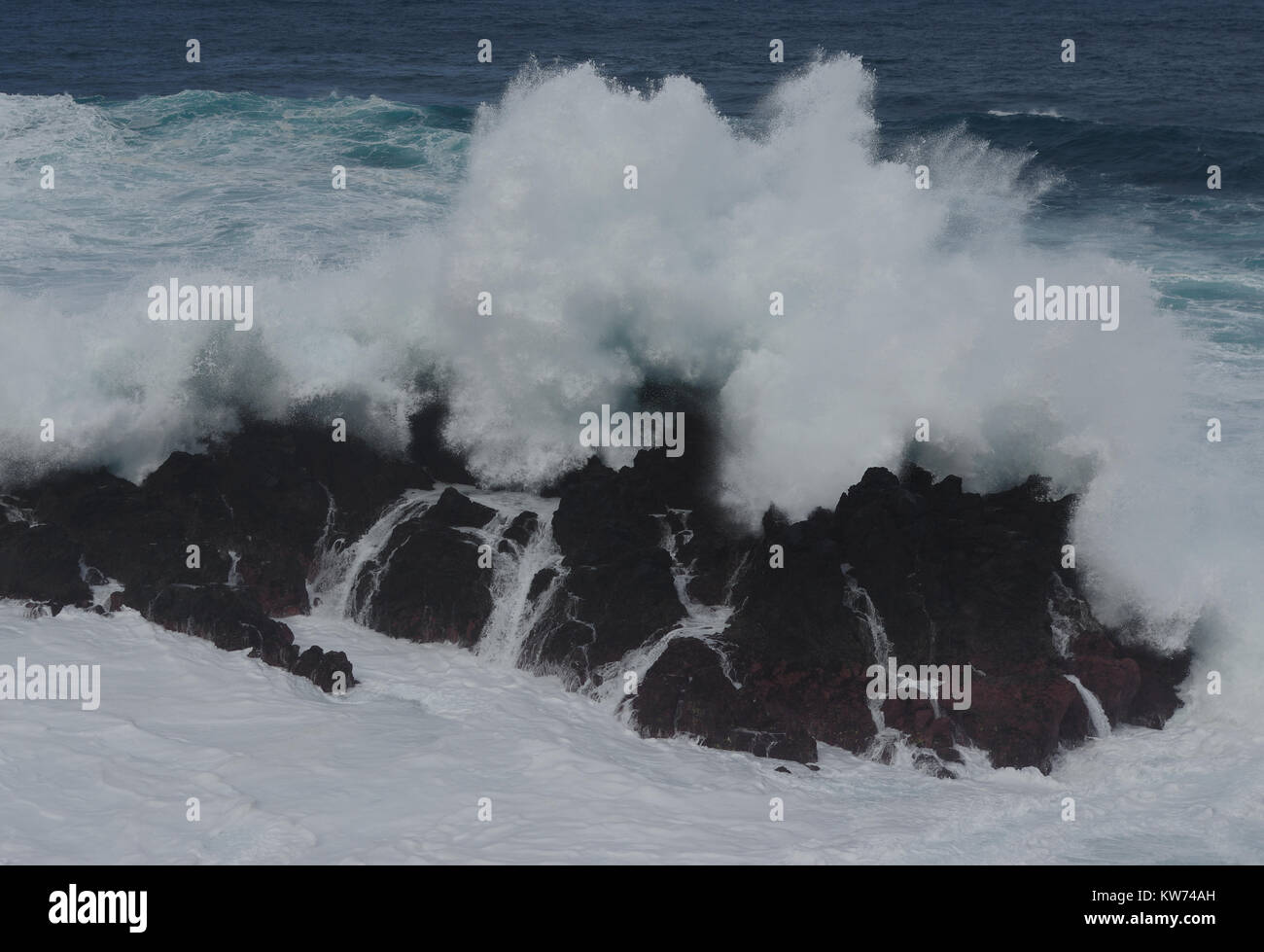 Rocky reef in surf while stormy weather Stock Photo