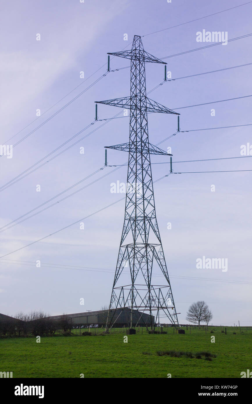 Electricity pylons bearing power supply across agricultural land with ...
