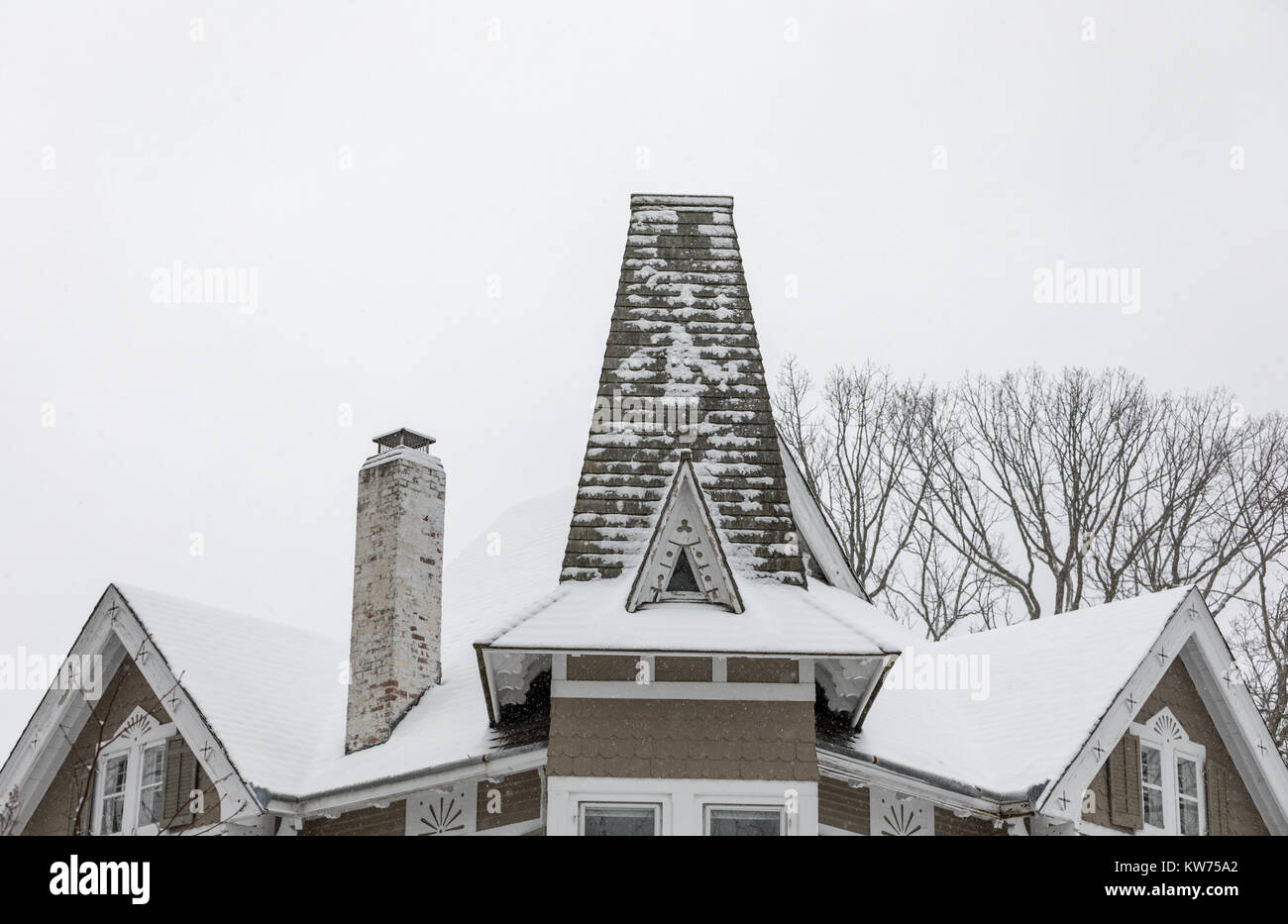 elaborate roof of an old house with snow Stock Photo