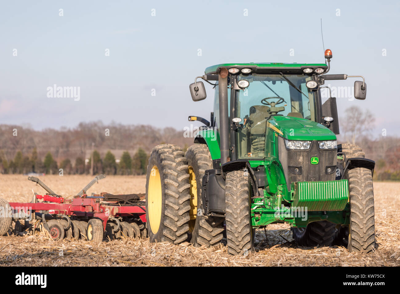 Large green john deere tractor sitting in a corn field in east hampton, ny Stock Photo