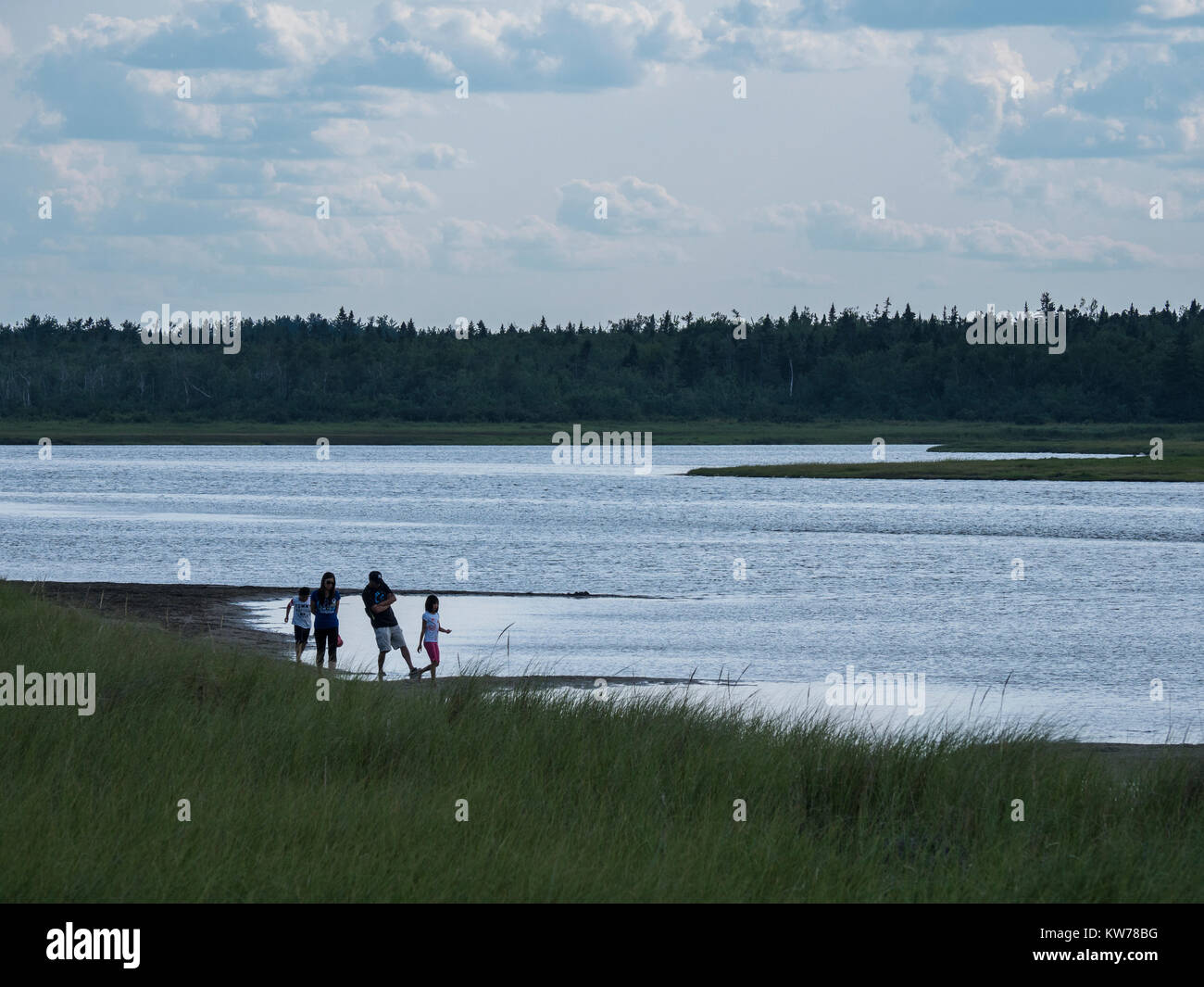 Family walks at the edge of the lagoon behind South Kouchibouguac Dune