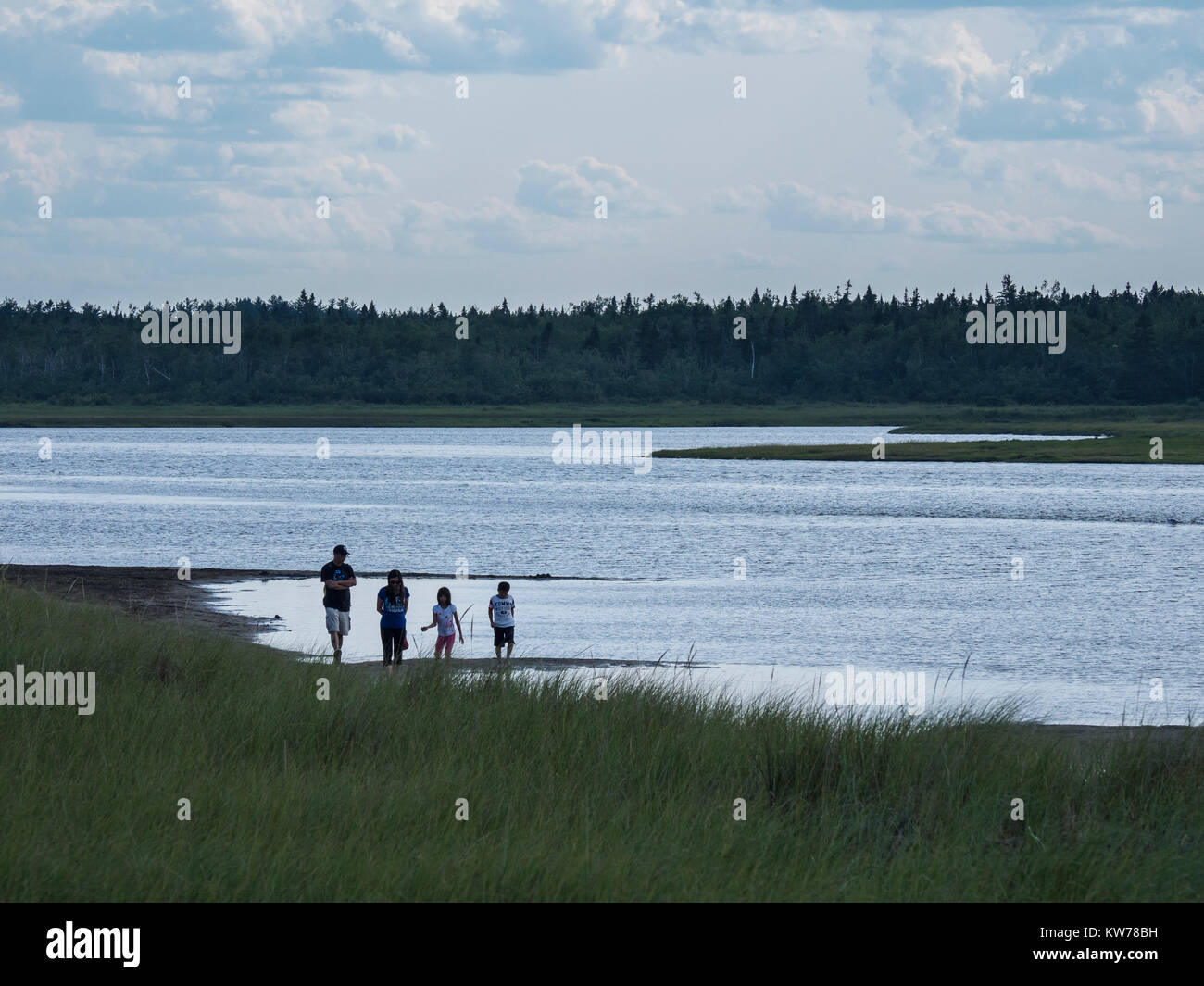 Family walks at the edge of the lagoon behind South Kouchibouguac Dune