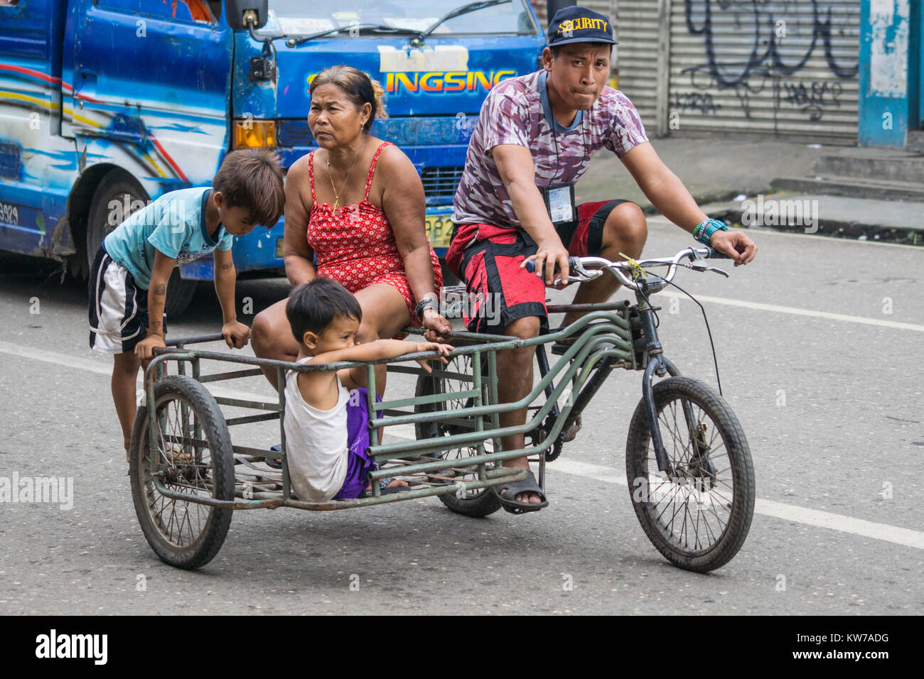 A family using a Trisikad for transportation,Cebu City,Philippines Stock Photo