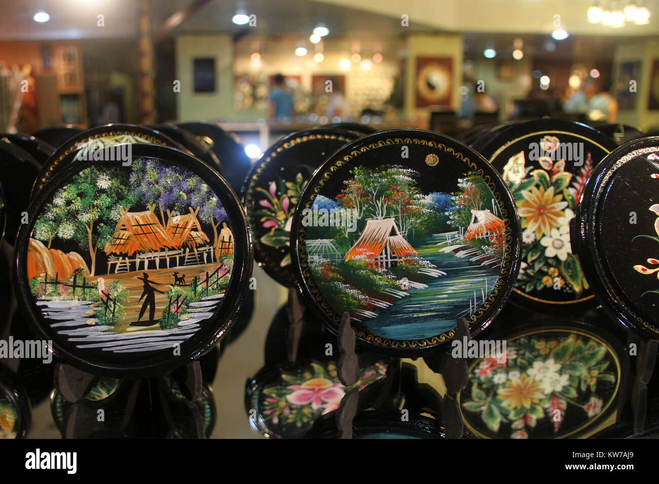 Wooden plates with pictures on the shelf in tourist souvenir shop