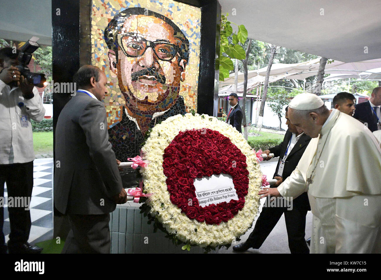 Pope Francis looks at a wreath in his homage beneath an image of Bangladesh's father of the nation, Sheikh Mujibur Rahman, at the Bangabandhu Memorial Museum in Dhaka, Bangladesh.  Featuring: Pope Francis Where: Dhaka, Bangladesh When: 30 Nov 2017 Credit: IPA/WENN.com  **Only available for publication in UK, USA, Germany, Austria, Switzerland** Stock Photo