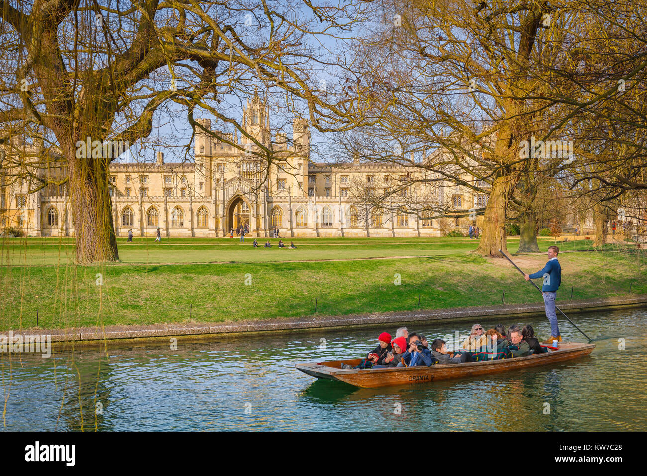 Punting Cambridge UK, on a spring morning in Cambridge, UK, tourists take a trip in a punt on the River Cam, gliding past St John's College. Stock Photo