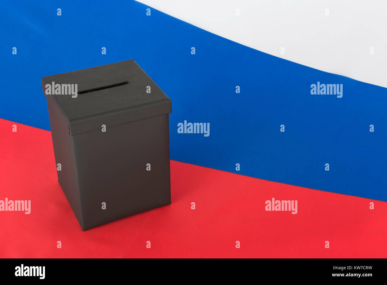 2024 Russian / fixed Russia elections concept - mock ballot box and Russian Federation flag - with copy space. Putin's rigged elections. Stock Photo