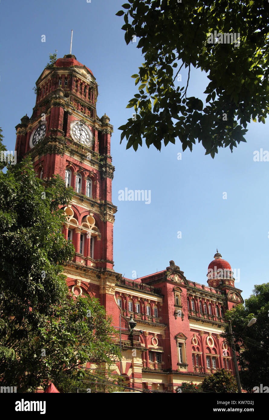 The iconic clock tower of the colonial red brick former High Court Building, Yangon, Myanmar. Stock Photo