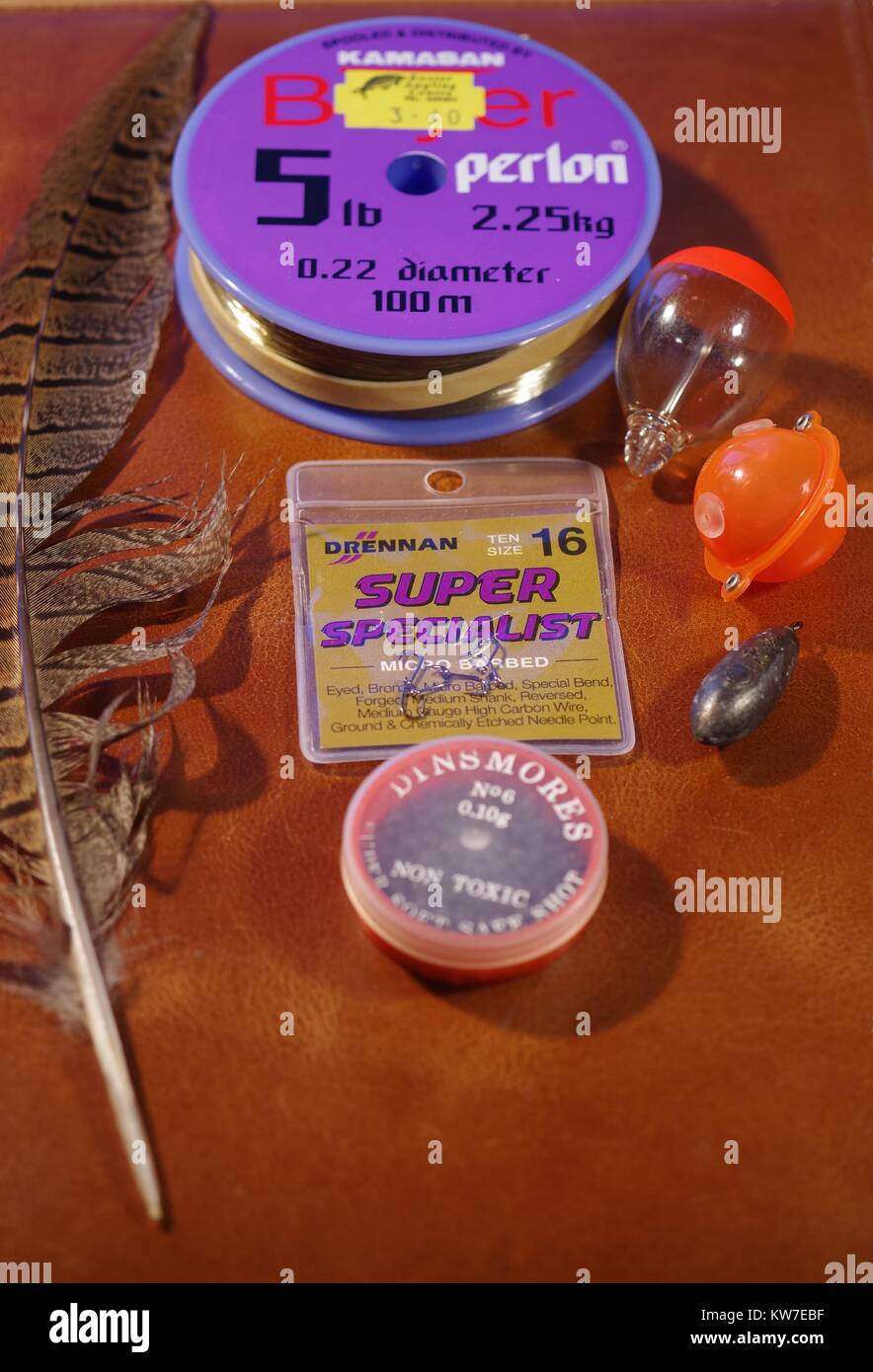 Fishing Tackle and Pheasant Feather on a Leather Case, Devon, UK