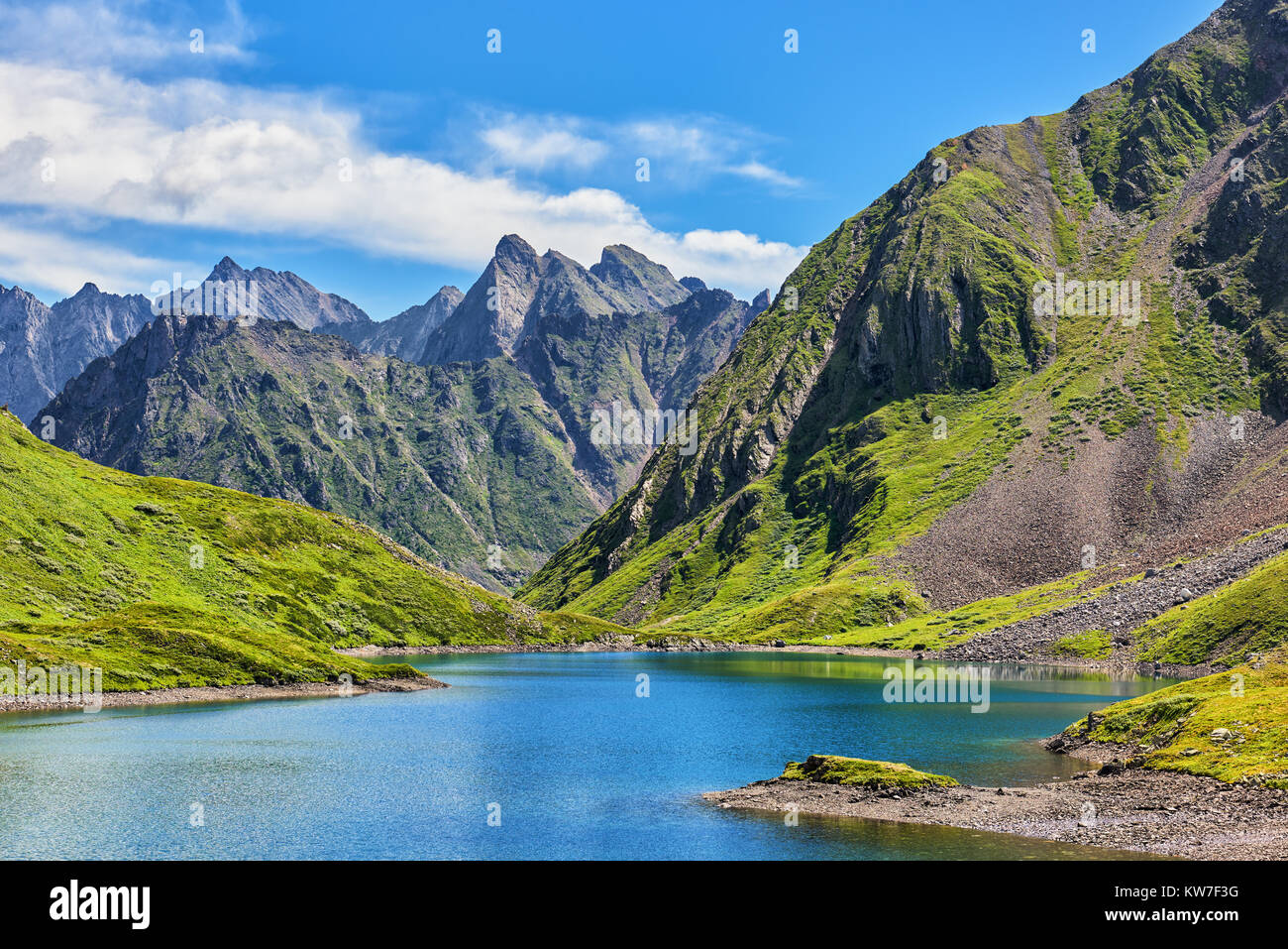 Mountain lake in alpine tundra of Siberian highlands. Bright sunny day in July. East Sayan. Russia Stock Photo