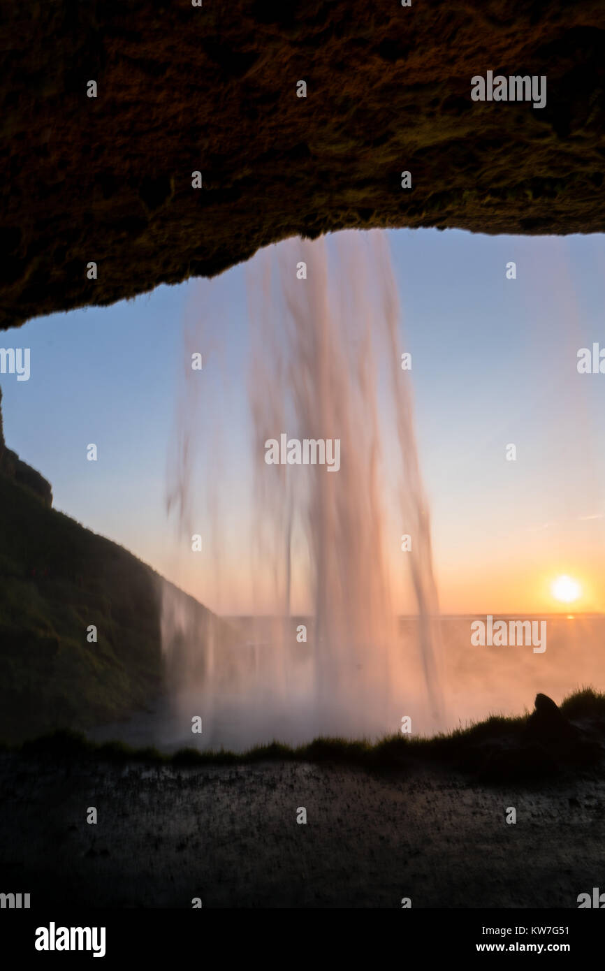 At the back of Seljalandsfoss waterfall in south of Iceland during ...