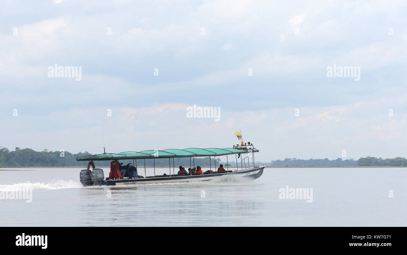 A fast ferry or water bus speeds along the Napo River near Coca or Puerto Francisco de Orellana. Coca, Puerto Francisco de Orellana, Orellana, Ecuador Stock Photo
