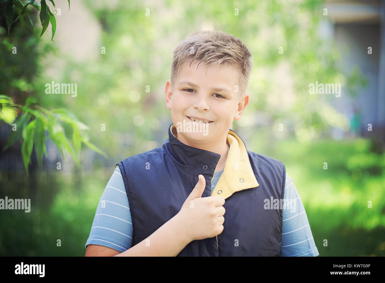 Young Boy Showing Thumbs Up Gesture Outdoors Stock Photo - Alamy