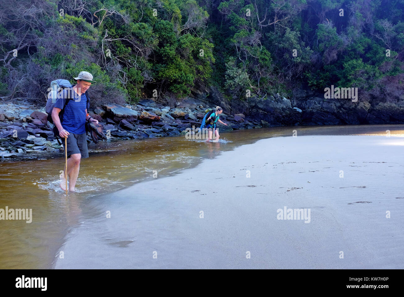 Hikers cross a river along the Otter Trail hike on the Garden Route in