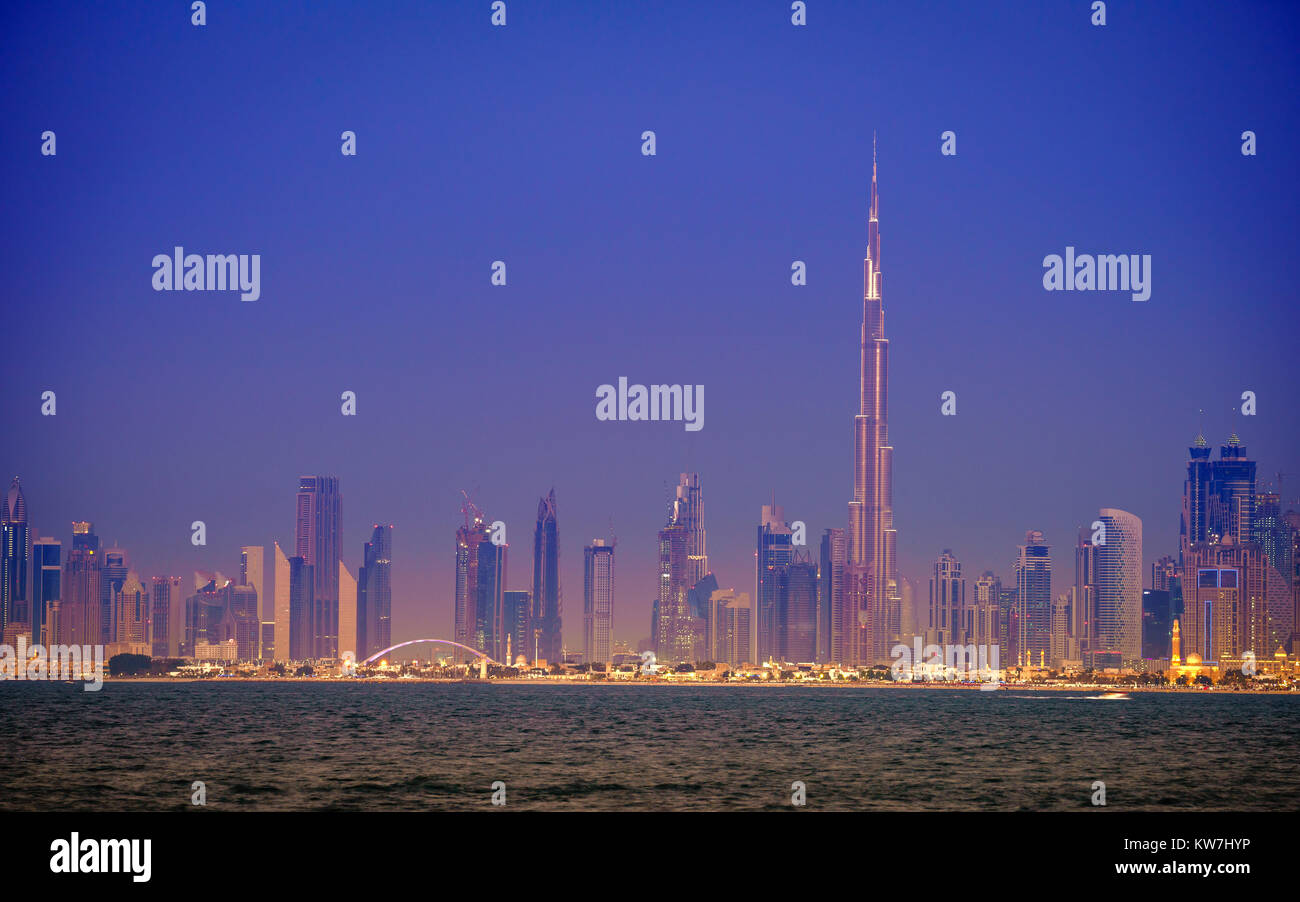 Seaside view of skyline of Dubai's downtown after sunset Stock Photo