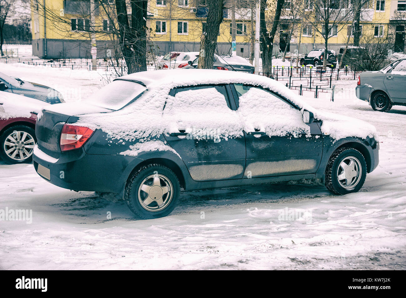 The cars in the Parking lot in the winter. Car covered with snow Stock ...