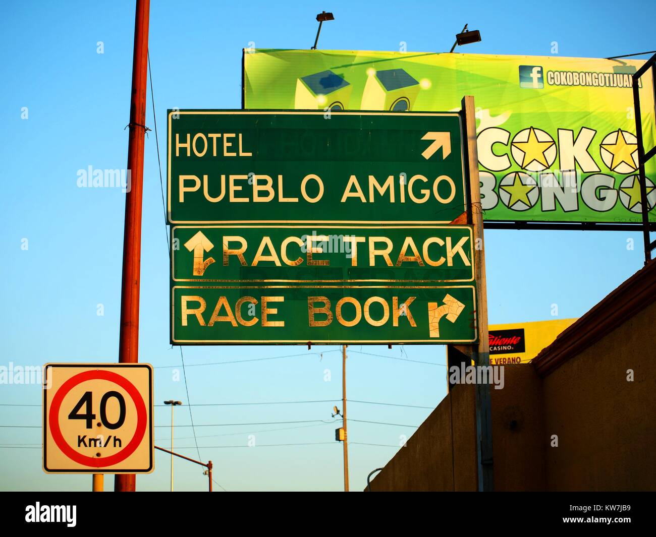 Street signage in Tijuana Mexico indicating directions to local hotel and race track Stock Photo