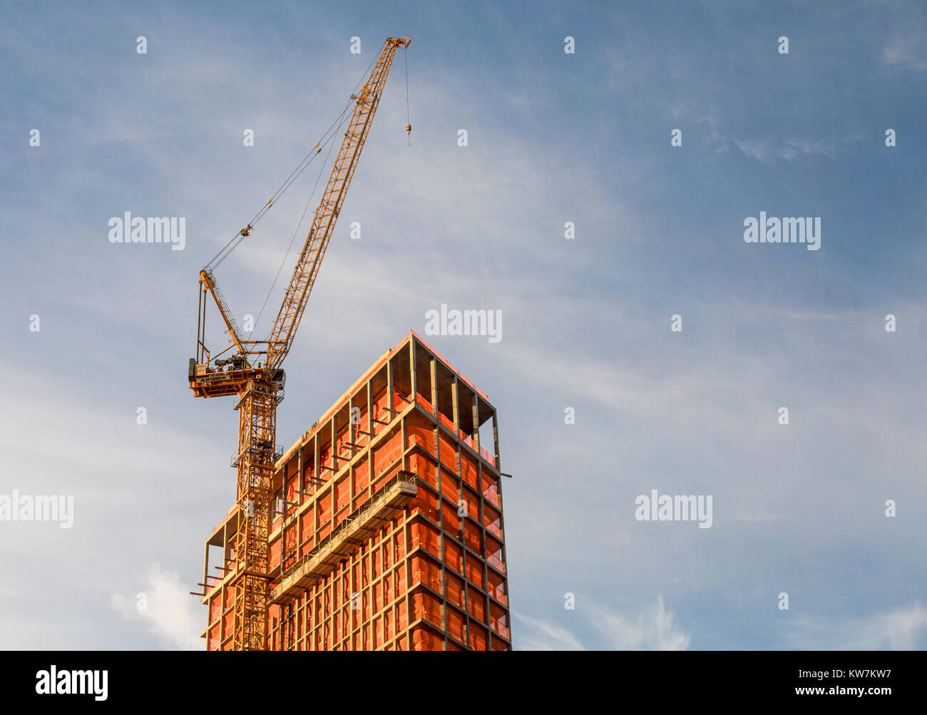 the top of a nyc building under construciton with a crane on the upper west side of manhattan Stock Photo