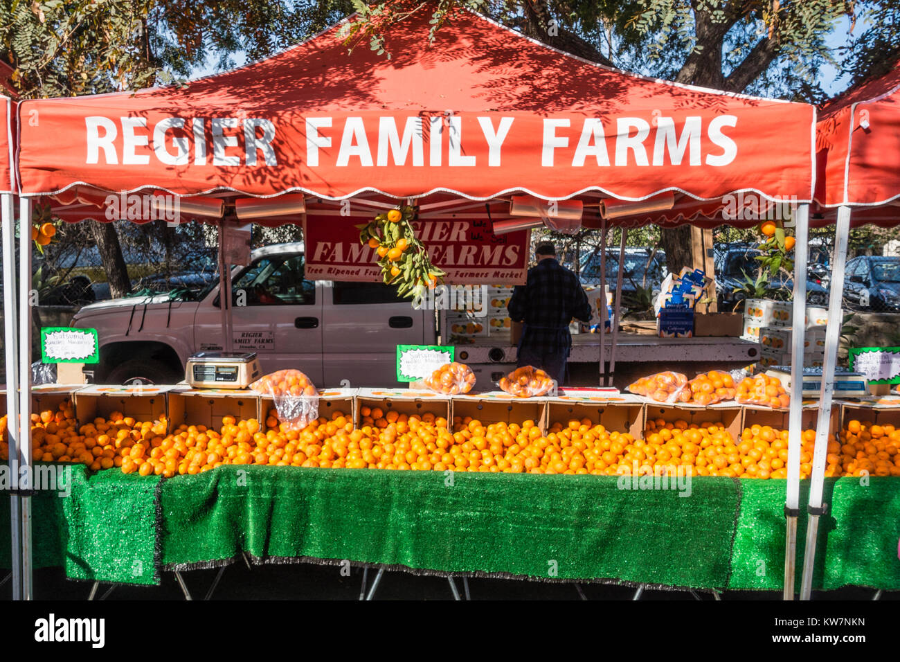 A family farm stand selling oranges at the Santa Barbara farmer's