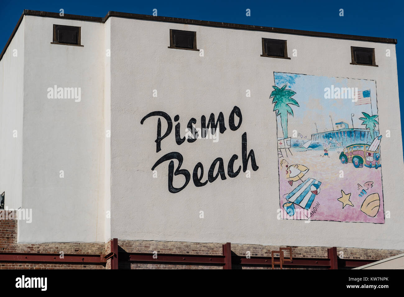 Pismo Beach ad on a multi-story building that includes a huge painting and the words 'Pismo Beach' next to it. Stock Photo