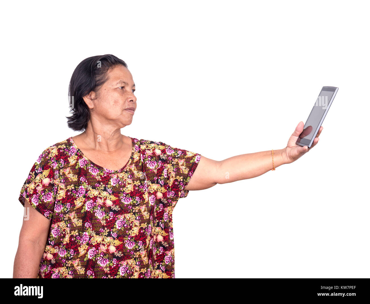 Elderly asian woman  holding digital tablet and stretch out forward to see clearly because of presbyopia isolated on white background Stock Photo