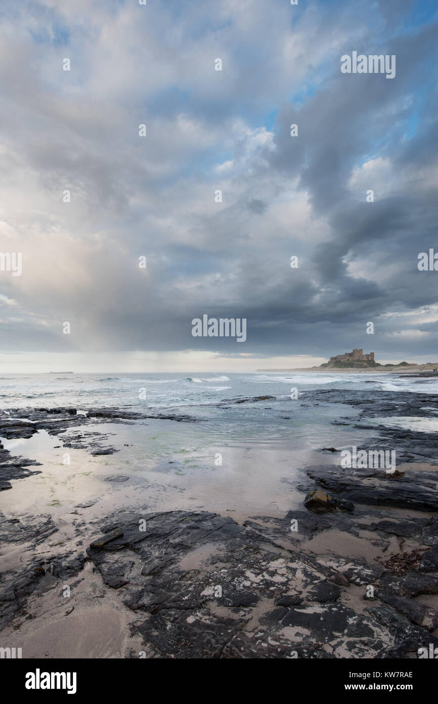 Bamburgh Castle in the late evening sunlight at sunset Stock Photo