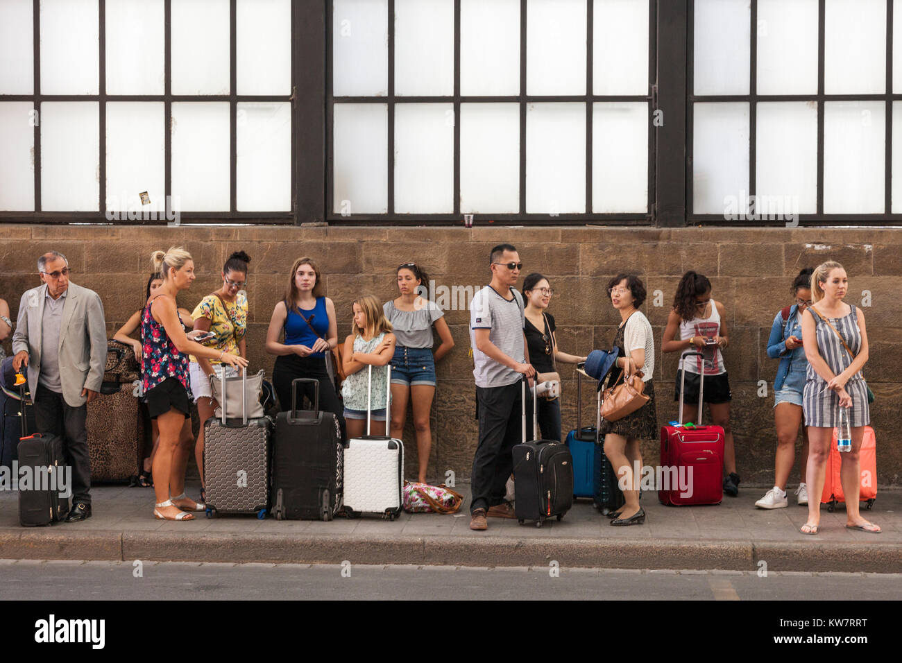 people waiting in line at a bus stop, Florence, Italy Stock Photo