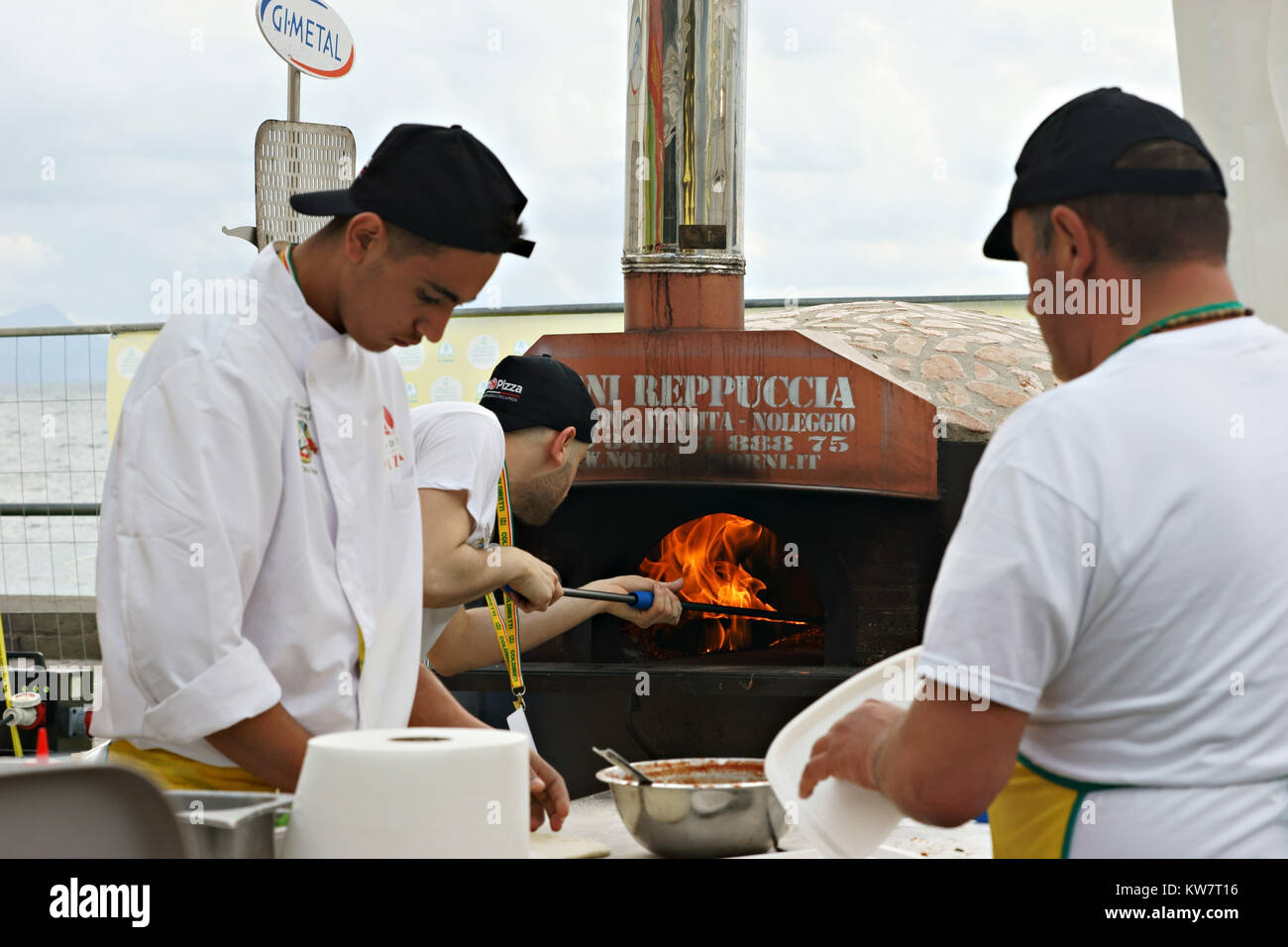 Neapolitan pizza-chef making pizza using a wood oven open air Stock Photo