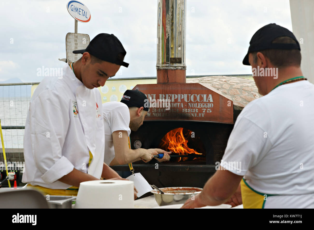 Neapolitan pizza-chef making pizza using a wood oven open air Stock Photo