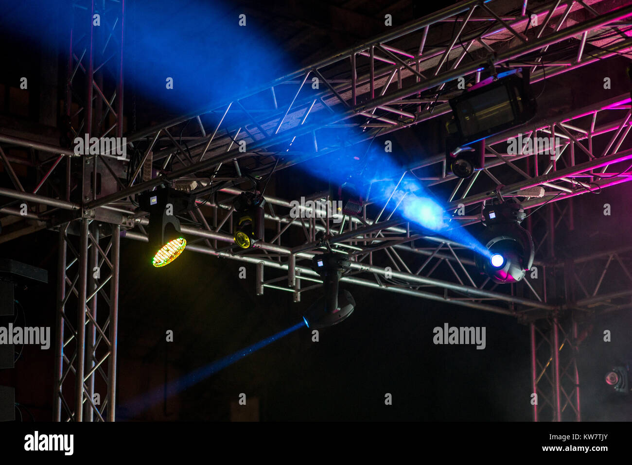 Stage lights and spotlights on metal construction during a concert ...