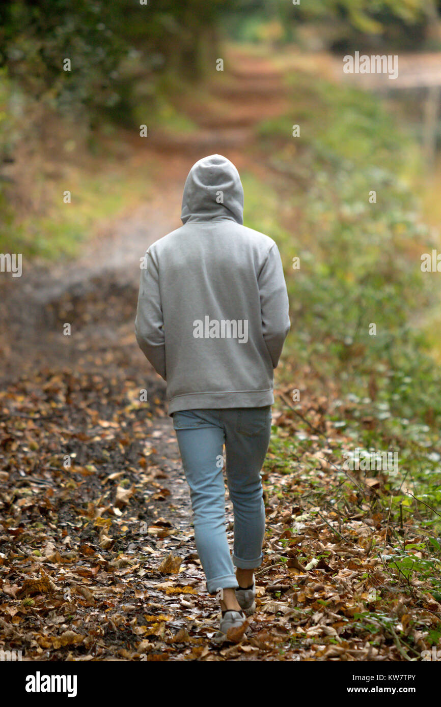 Someone Outside A young adult male walking alone outside on an autumn day Stock Photo ...