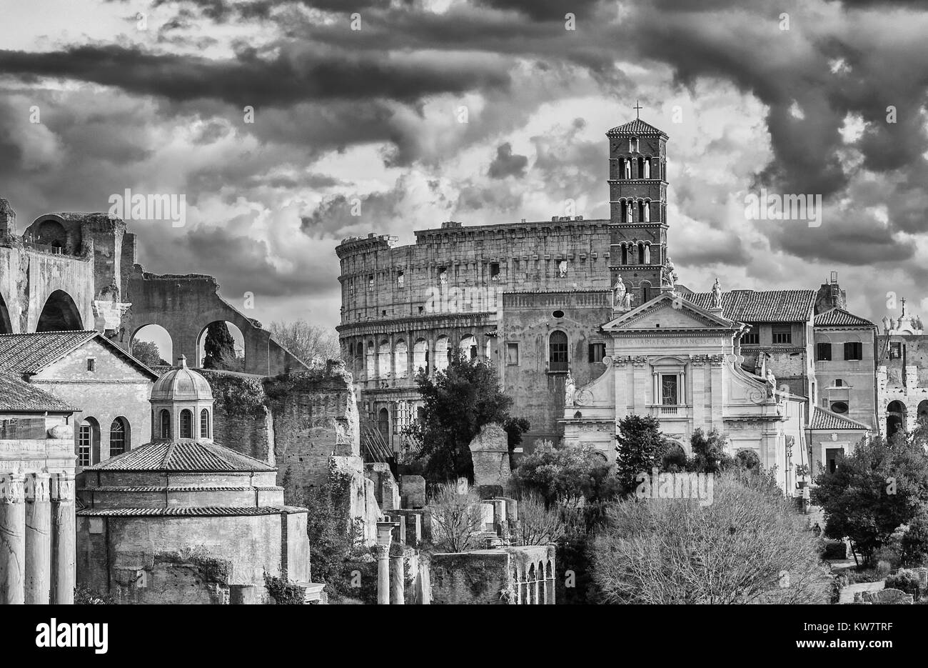 Saint Frances of Rome Church and Coliseum ruins seen from Capitoline Hill with beautiful clouds (Black and White) Stock Photo