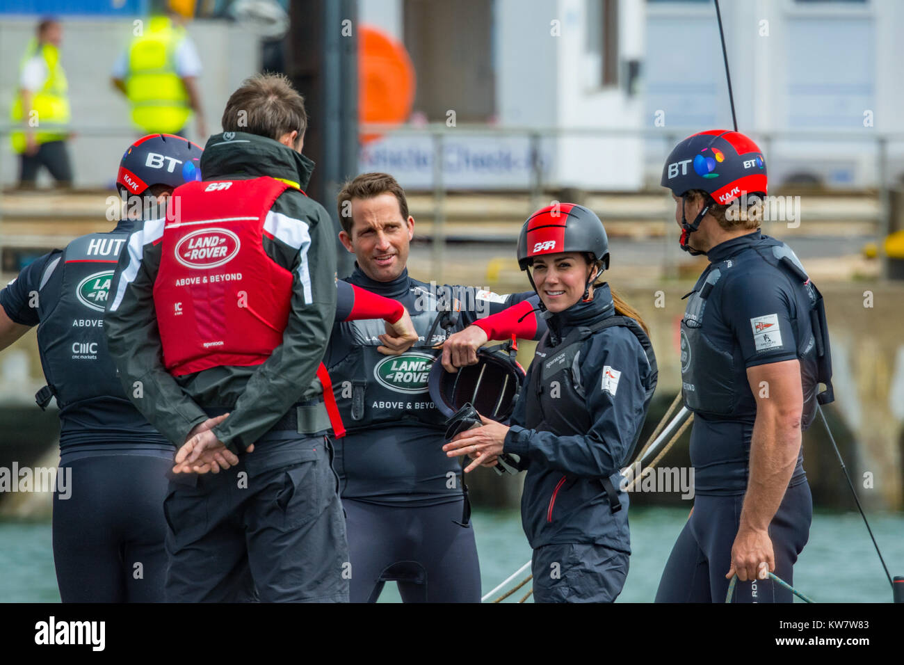 The Duchess of Cambridge smiles for the camera whilst talking to Sir Ben Ainslie and his colleagues during a visit to Portsmouth, UK on 20th May 2016. Stock Photo