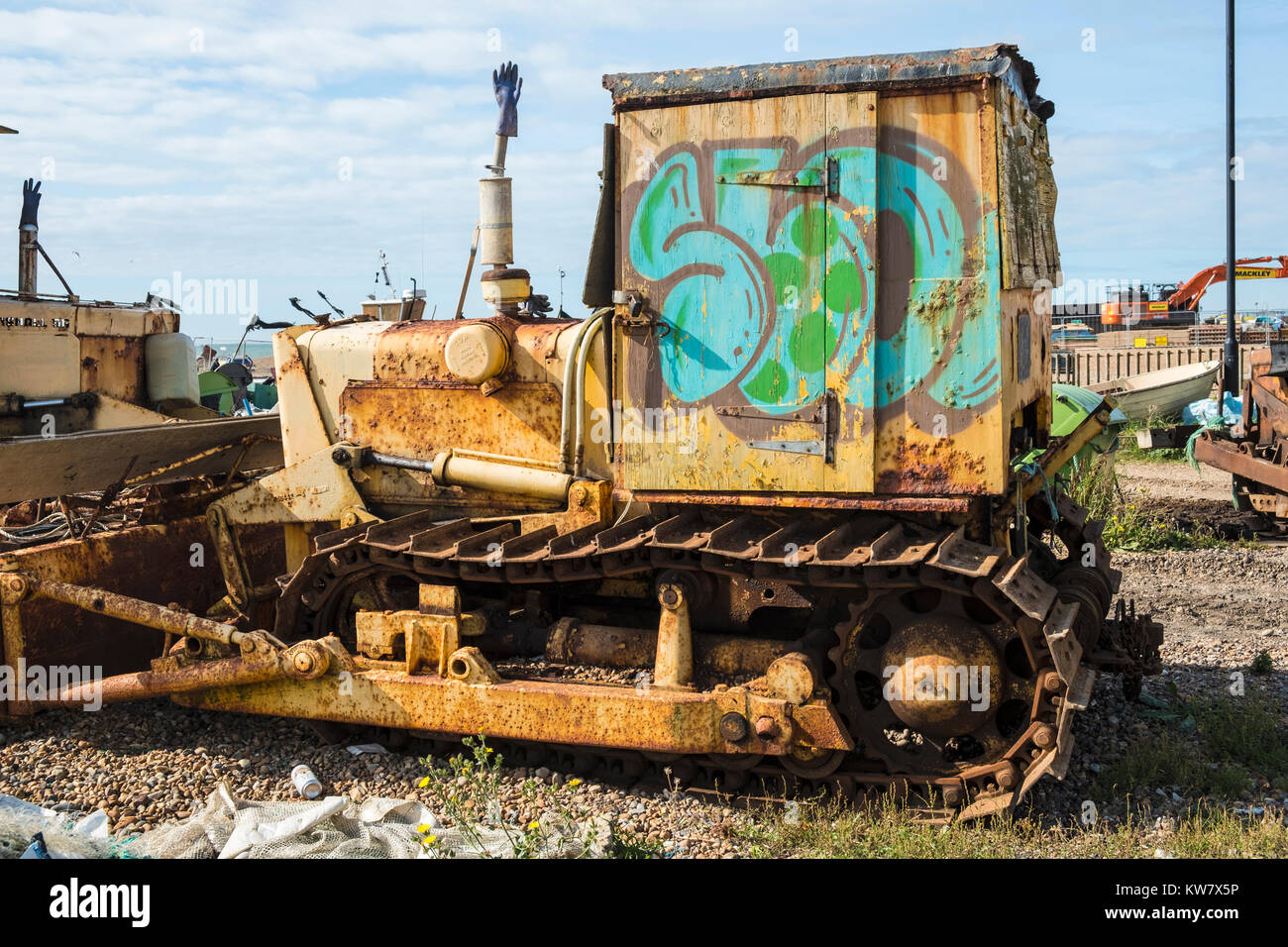 Rusty old beach bulldozer with graffiti on Hastings fishermens beach, the Stade, East Sussex, UK Stock Photo