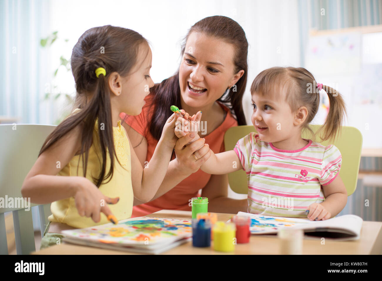 Children and mother with finger paints Stock Photo
