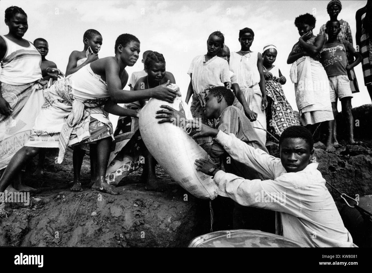 During severe flooding in Mozambique in March 2000,  stranded communities on the Save river, Inhabane Province, land supplies brought by volunteers in small speed boats. Stock Photo