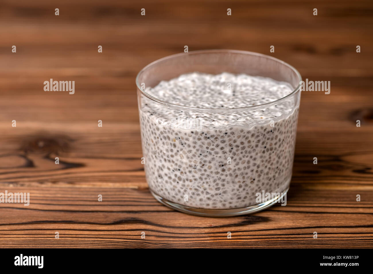 chia seed pudding in glass on wooden background, minimal design Stock Photo