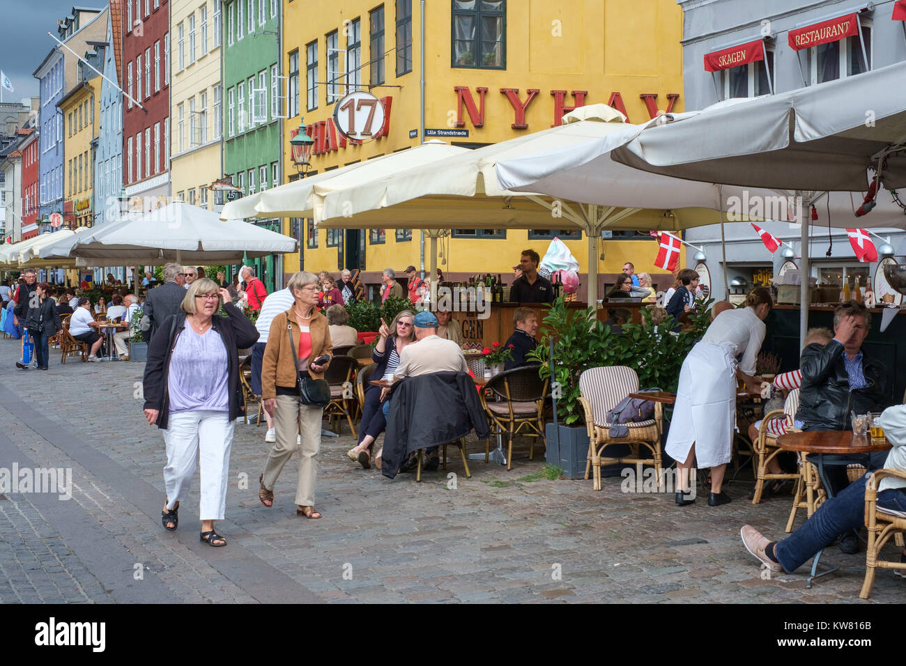 Restaurant at Nyhavn, a 17th century harbor district in the center of Copenhagen and currently a popular waterfront tourist attraction. Stock Photo